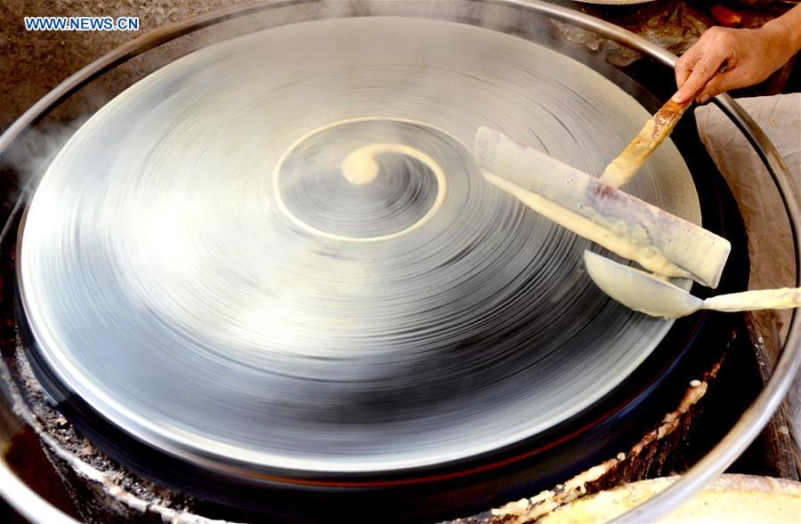 Villagers make traditional food for coming Spring Festival in E China