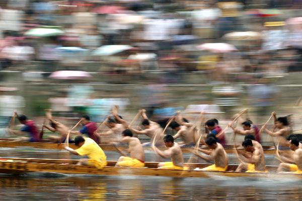 Participants compete in dragon boat races before Dragon Boat Festival