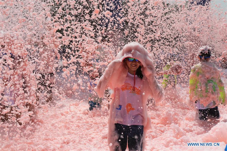 People take part in bubble run in Beijing