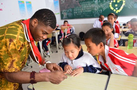 Foreign students volunteering teaching for village students