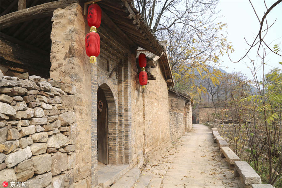 US man building mud house in rural China