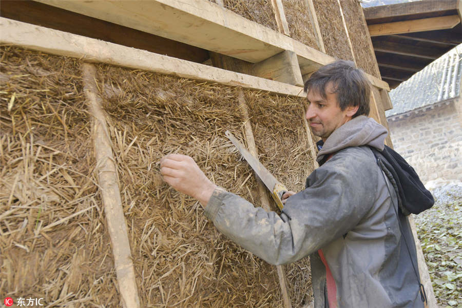 US man building mud house in rural China