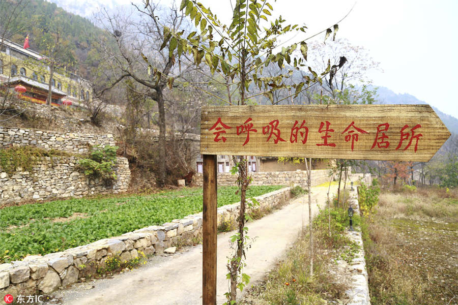 US man building mud house in rural China