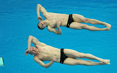 Olympic champion Dmitry Sautin (front), known as Russia's 'Diving czar', competes in the men's 3m synchro springboard event at the 16th FINA Diving World Cup in Beijing's National Aquatics Center, the venue built for the upcoming Olympics. The pair won the silver medal. [Xinhua]