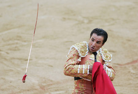 Spanish bullfighter Jose Prados "El Fundi" is tossed by a bull during a bullfight at Pamplona's bullring during the San Fermin festival July 9, 2006. A pack of fighting bulls run through the centre of the town to the bullring every morning during the week-long festival made famous by U.S. writer Ernest Hemingway. [Reuters]