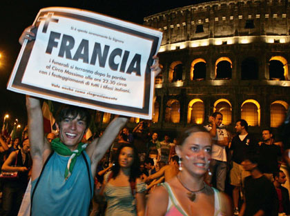 A soccer fan holds a mock funeral notice for France while celebrating Italy's World Cup 2006 triumph outside the Colosseum in Rome July 9, 2006. The notice reads, "funeral for Mr France after the match at Circus Maximus approx 22.30". [Reuters]