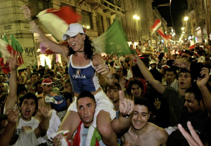 A soccer fan holds a mock funeral notice for France while celebrating Italy's World Cup 2006 triumph outside the Colosseum in Rome July 9, 2006. The notice reads, "funeral for Mr France after the match at Circus Maximus approx 22.30". [Reuters]