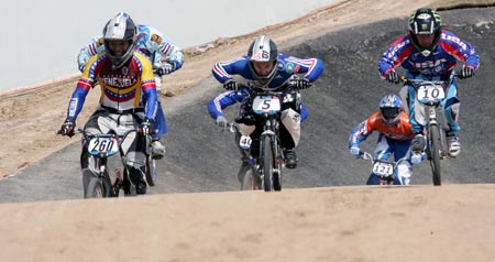 Competitors ride over the course during the UCI BMX Supercross World Cup at Laoshan Bicycle Moto Cross (BMX) venue in Beijing August 21, 2007.[Xinhua]