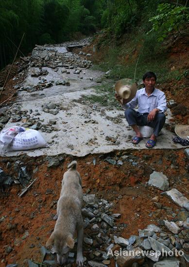 Villagers rebuild sole road after flood