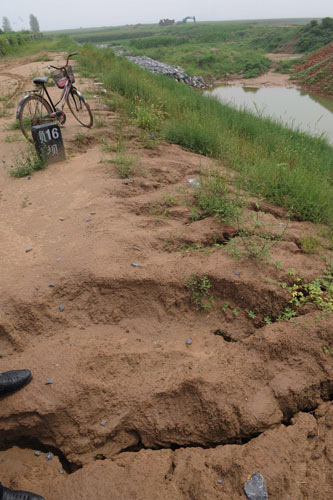 New dike suffers dozens of cave-ins after rain