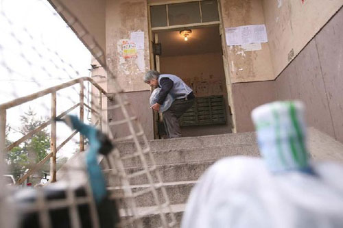 Woman in her 70s delivers water to support family