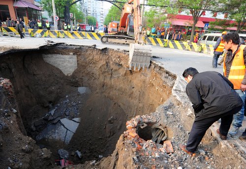 Road caves in, swallowing truck