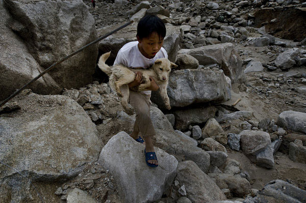 Family lost to landslide, boy is left with dog