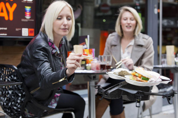 Flying trays keep customers amused