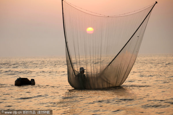 Fisherman stilted against power of the sea