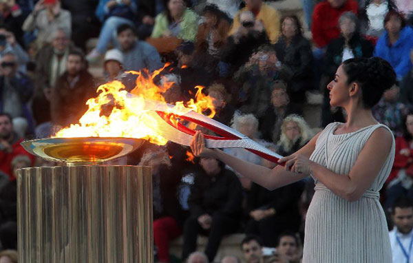 Olympic flame handed over to Russian hosts