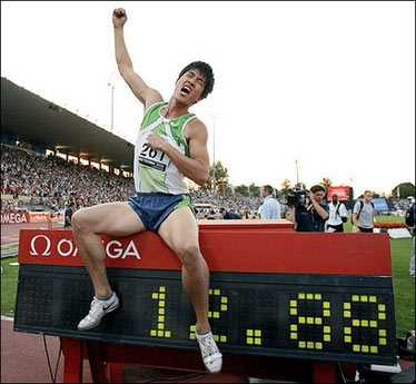 New world record holder China's Liu Xiang gestures with the time he set in the men's 110m Hurdles at the athletics IAAF Super Grand Prix Athletissima, in Lausanne. Liu scorched to the finishing line in a time of 12.88sec, beating the old mark of 12.91 that he shared with Britain's Colin Jackson and which had stood since 1993.(