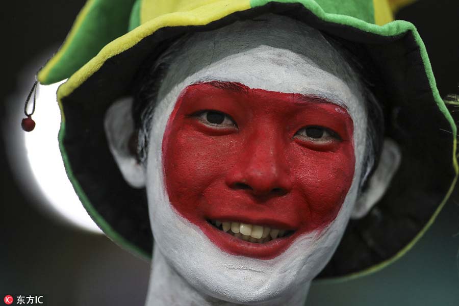 Fans with face paint celebrate Olympics