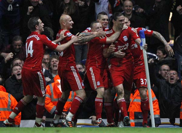 Carroll header lifts 10-man Liverpool