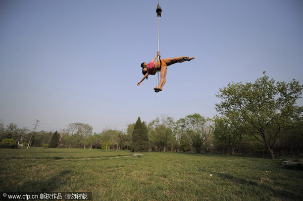 Crane hoists pole dancers in air