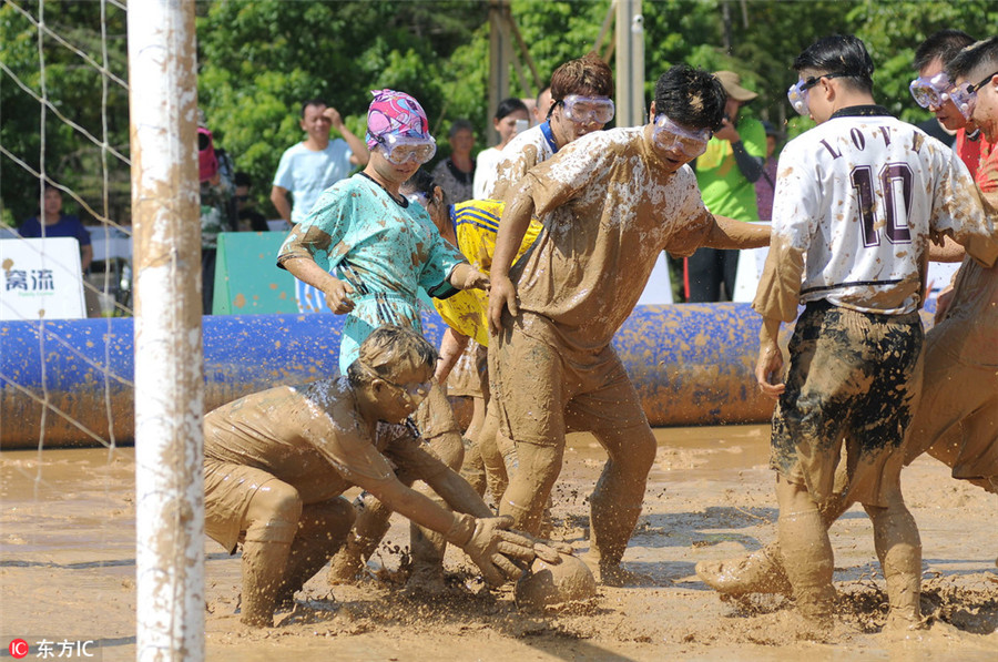 Swamp soccer: Players battle for ball in Nanjing