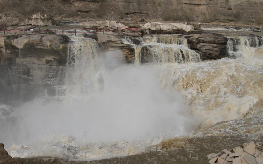 Surging water at Hukou Waterfall attracts tourists