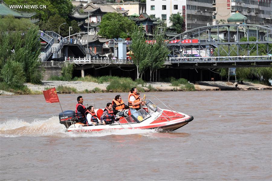 Tourists take sightseeing speedboat on Yellow River in China's Lanzhou