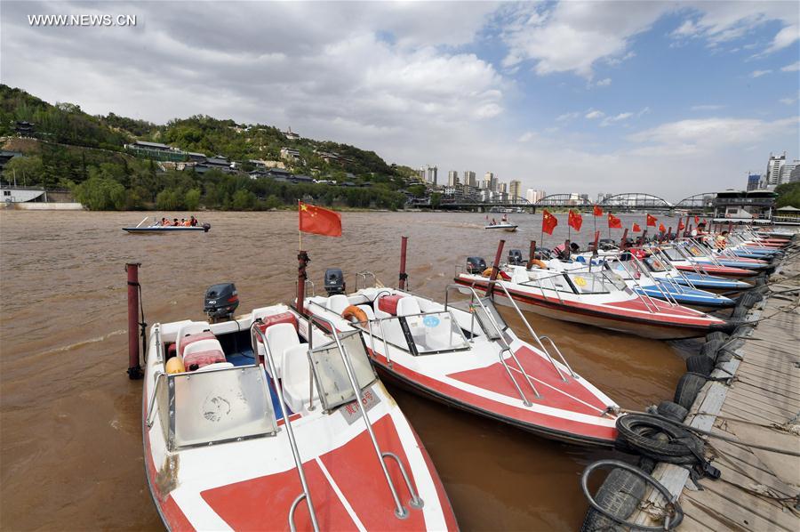 Tourists take sightseeing speedboat on Yellow River in China's Lanzhou