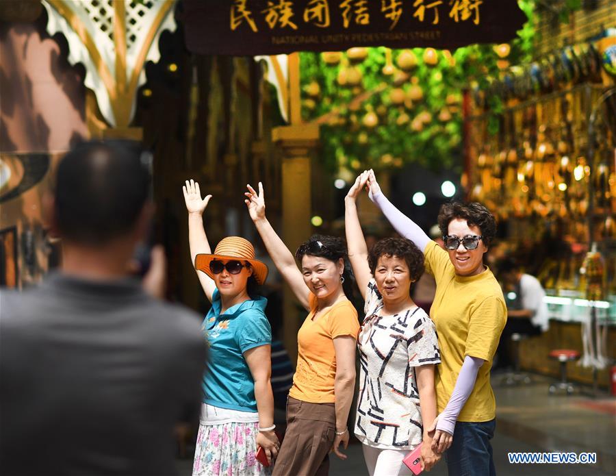 Tourists visit Int'l Bazar at Urumqi in NW China's Xinjiang