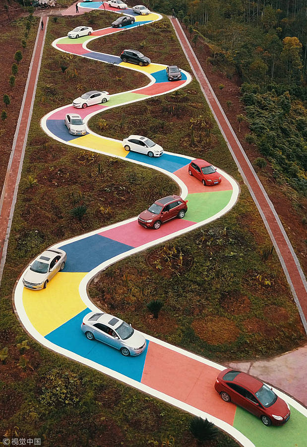 Snakelike colorful road draws tourists