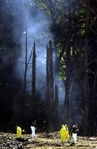 Smoke rises from the debris of United Flight 93 near Shanksville, Pennsylvania, September 12, 2001. The jury deciding whether Zacarias Moussaoui should die heard the dramatic cockpit recording on Wednesday of passengers struggling to thwart hijackers in flight 93. [Reuters/File]