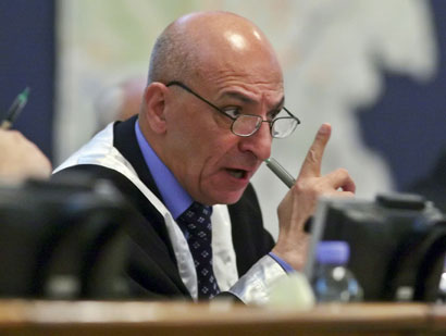 Iraqi Judge Raouf Abdul Rahman addresses former Iraqi president Saddam Hussein after sentencing him to death during his trial in Baghdad's heavily fortified Green Zone November 5, 2006. A visibly shaken Saddam Hussein was found guilty of crimes against humanity and sentenced to hang on Sunday at a lightning session of the U.S.-backed court trying him in Baghdad. 