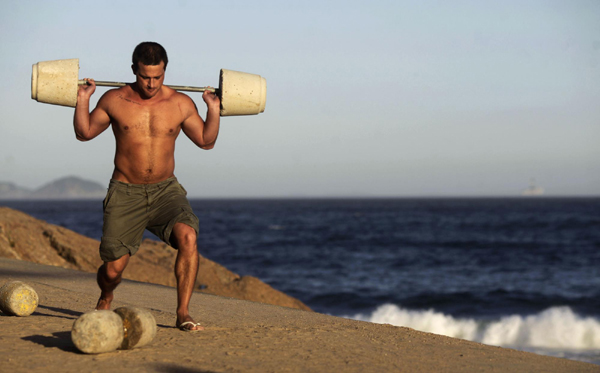 Men work out using cement-made weights