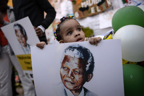 Mandela's condition 'improving' as Obama flies in