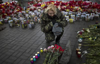 Troop carriers enter east Ukraine town bearing Russian flag