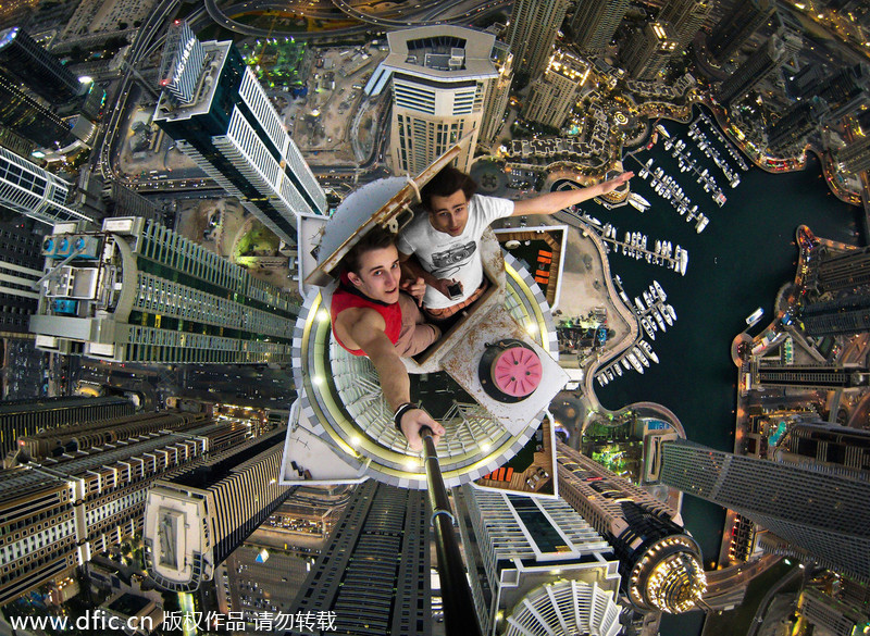 Daredevils taking selfie over Dubai skyscraper