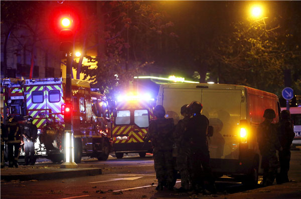 Over 100 dead in Paris shootings, hostages held: French media