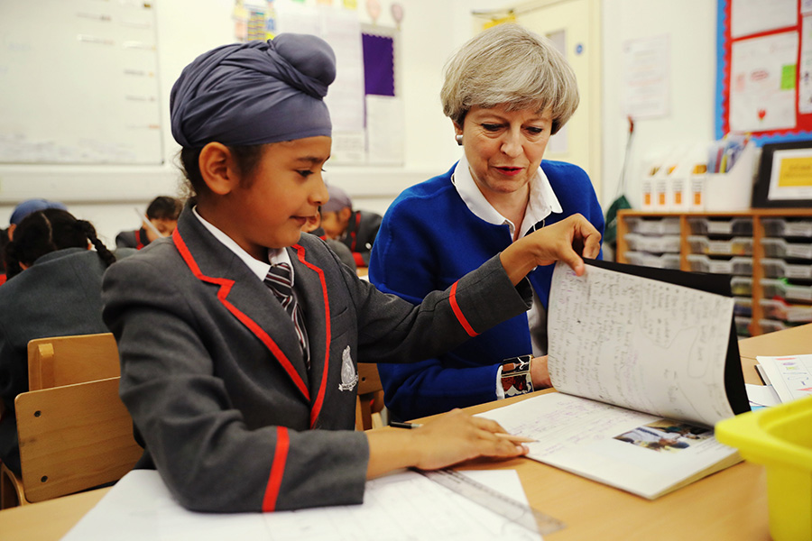 Britain's PM May meets pupils of primary school in Birmingham