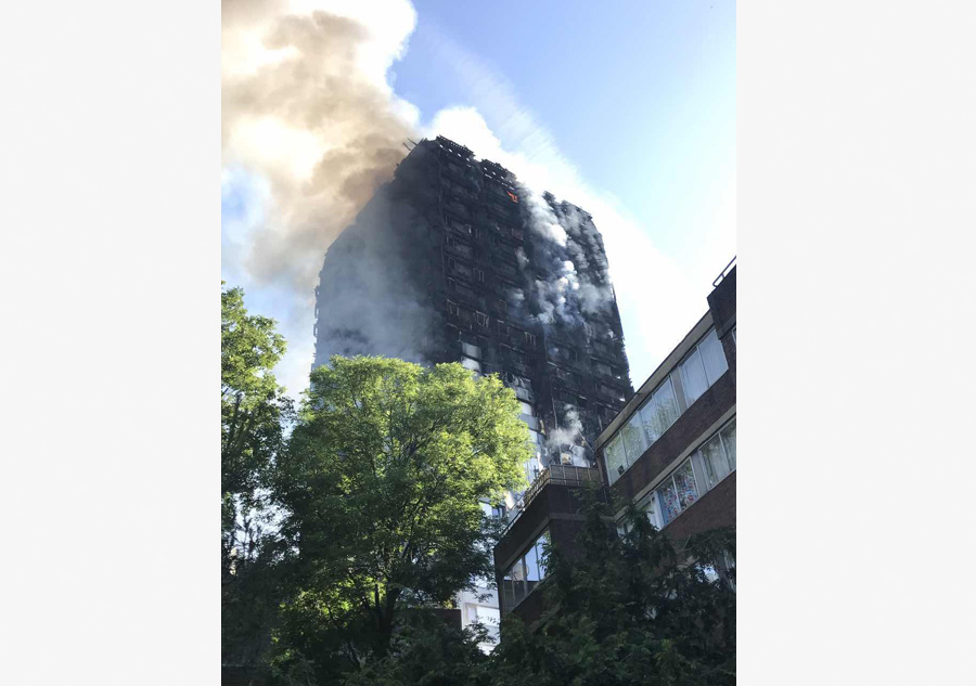 Fire engulfs London tower block, at least 12 dead