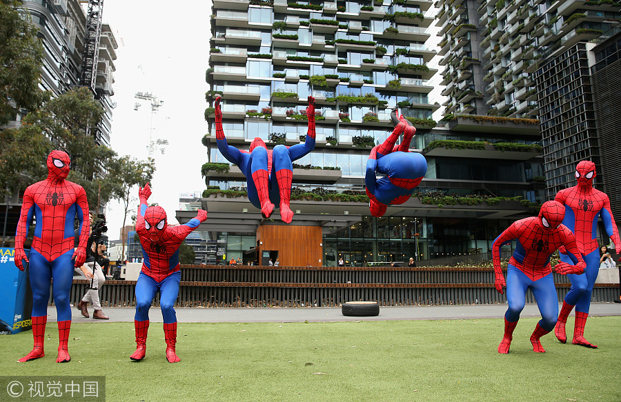 Parkour athletes dressed as spiderman scale Sydney mall