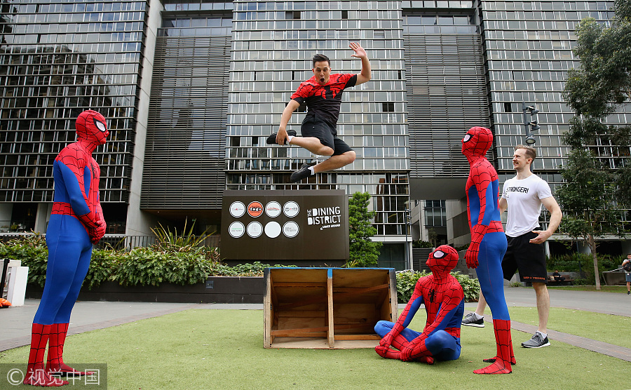 Parkour athletes dressed as spiderman scale Sydney mall